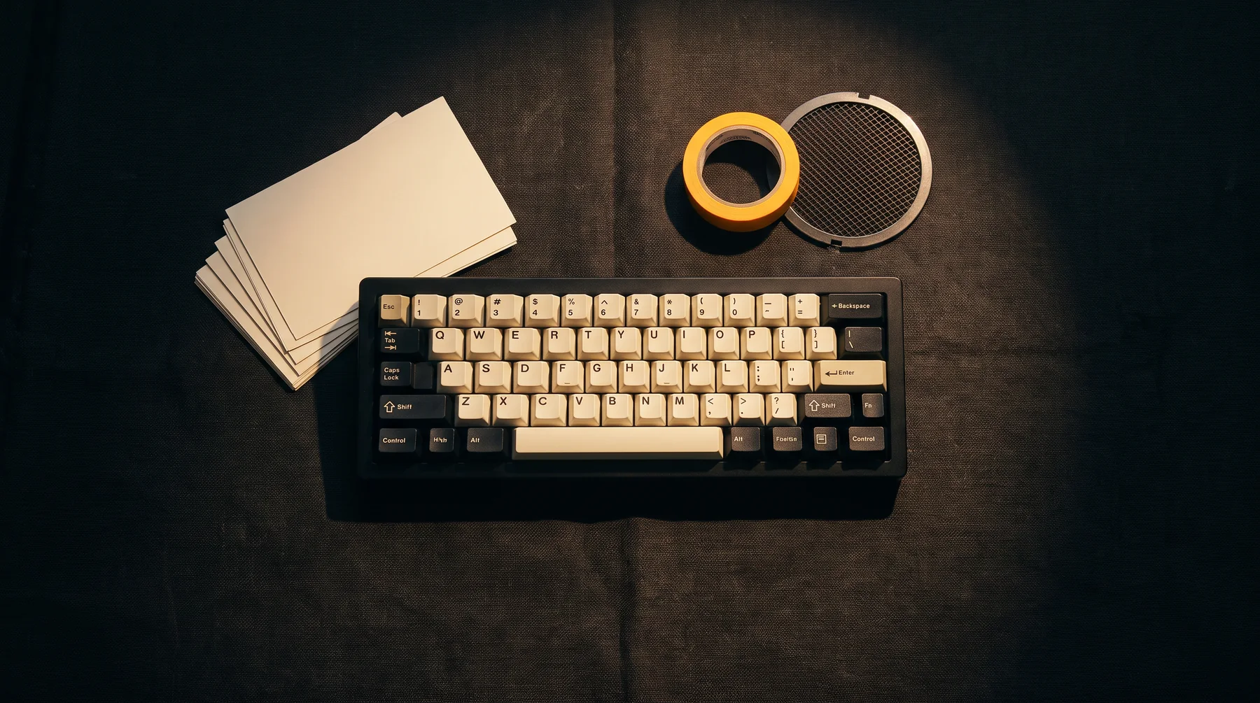 Keyboard and notebook prepared on a dark table